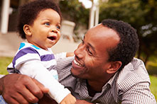 Smiling dad and young son