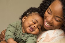 African American mother and baby daughter hugging