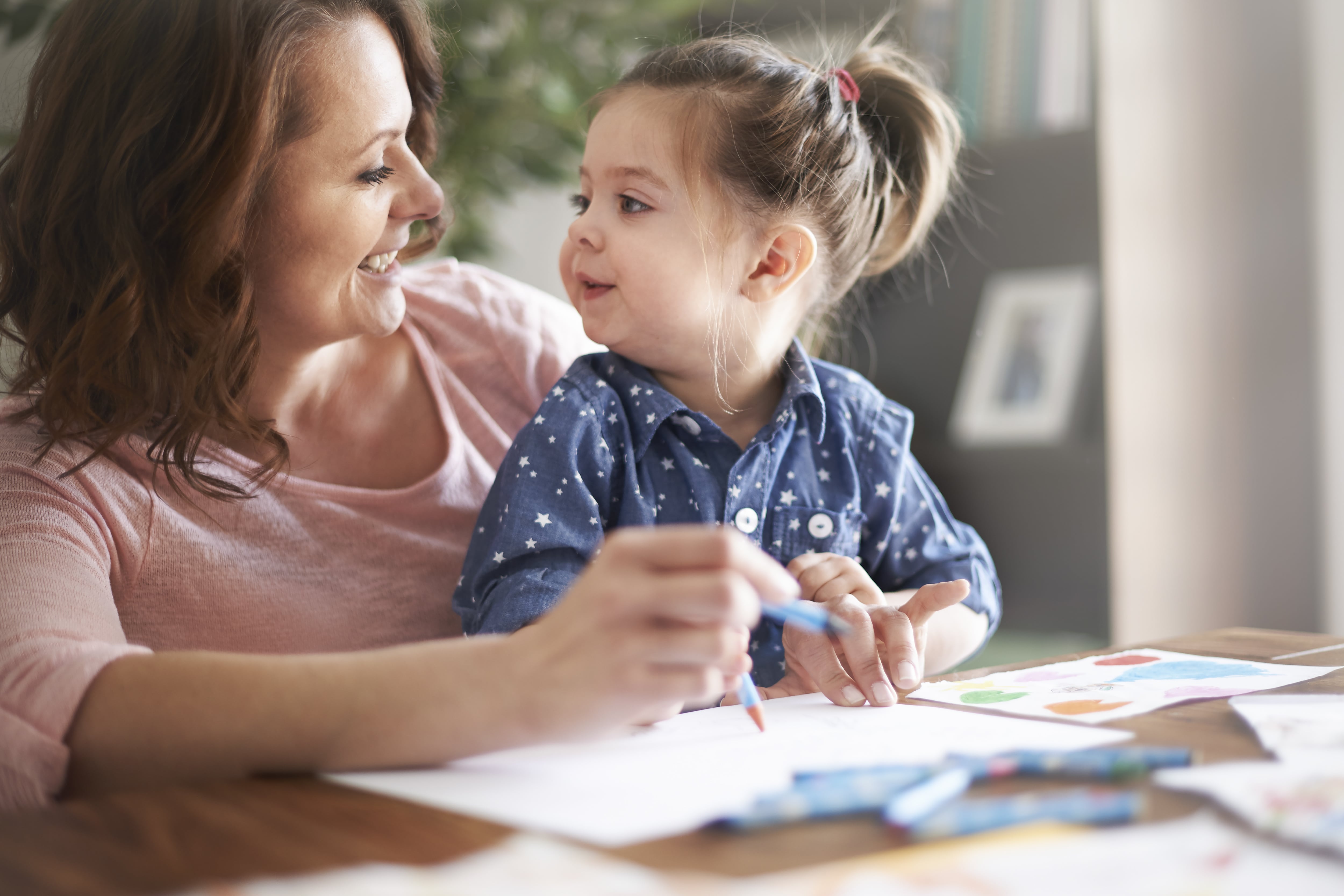 Mom and daughter coloring with crayons