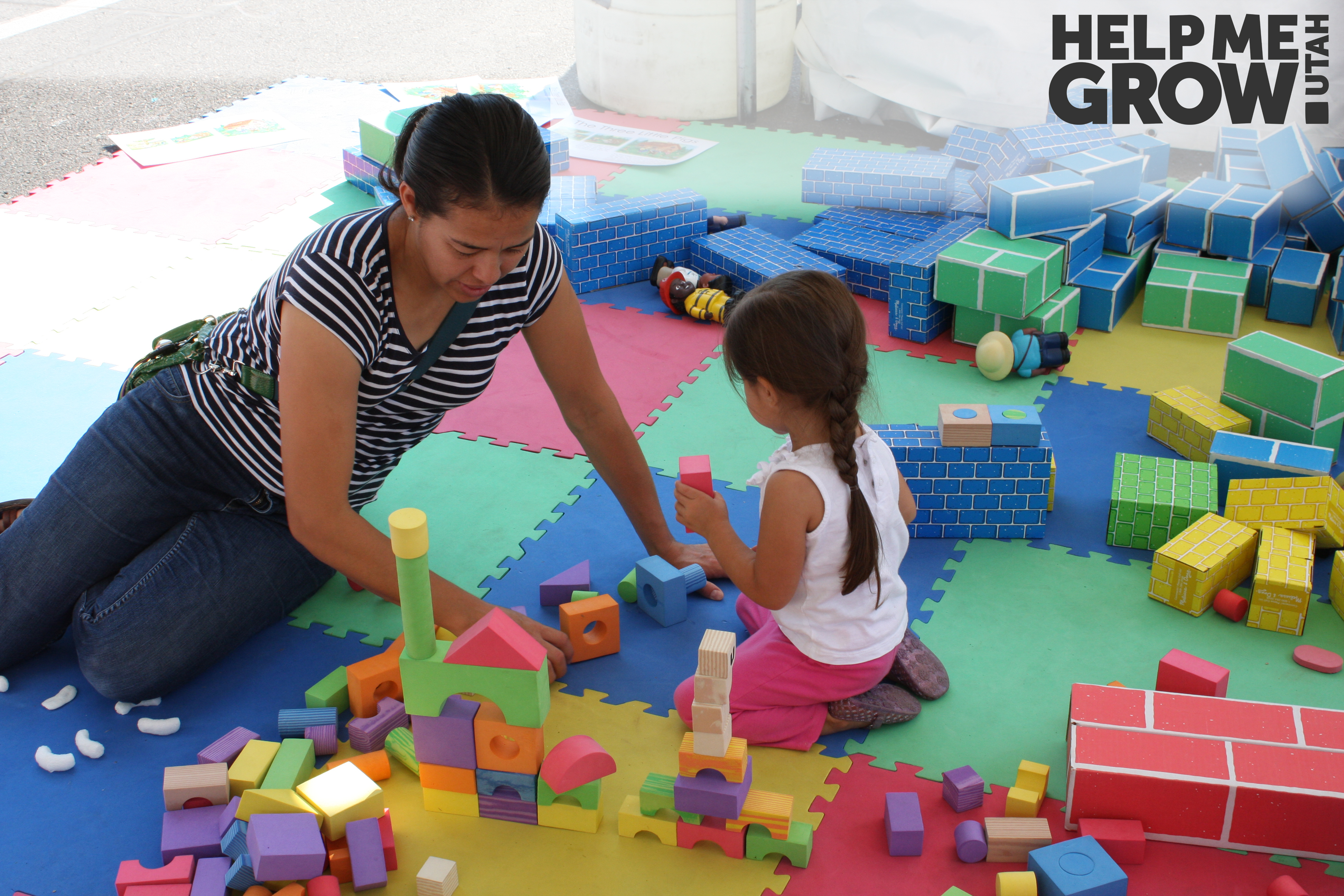 Mother and young daughter stack blocks together at a Books Blocks & Balls event in Utah