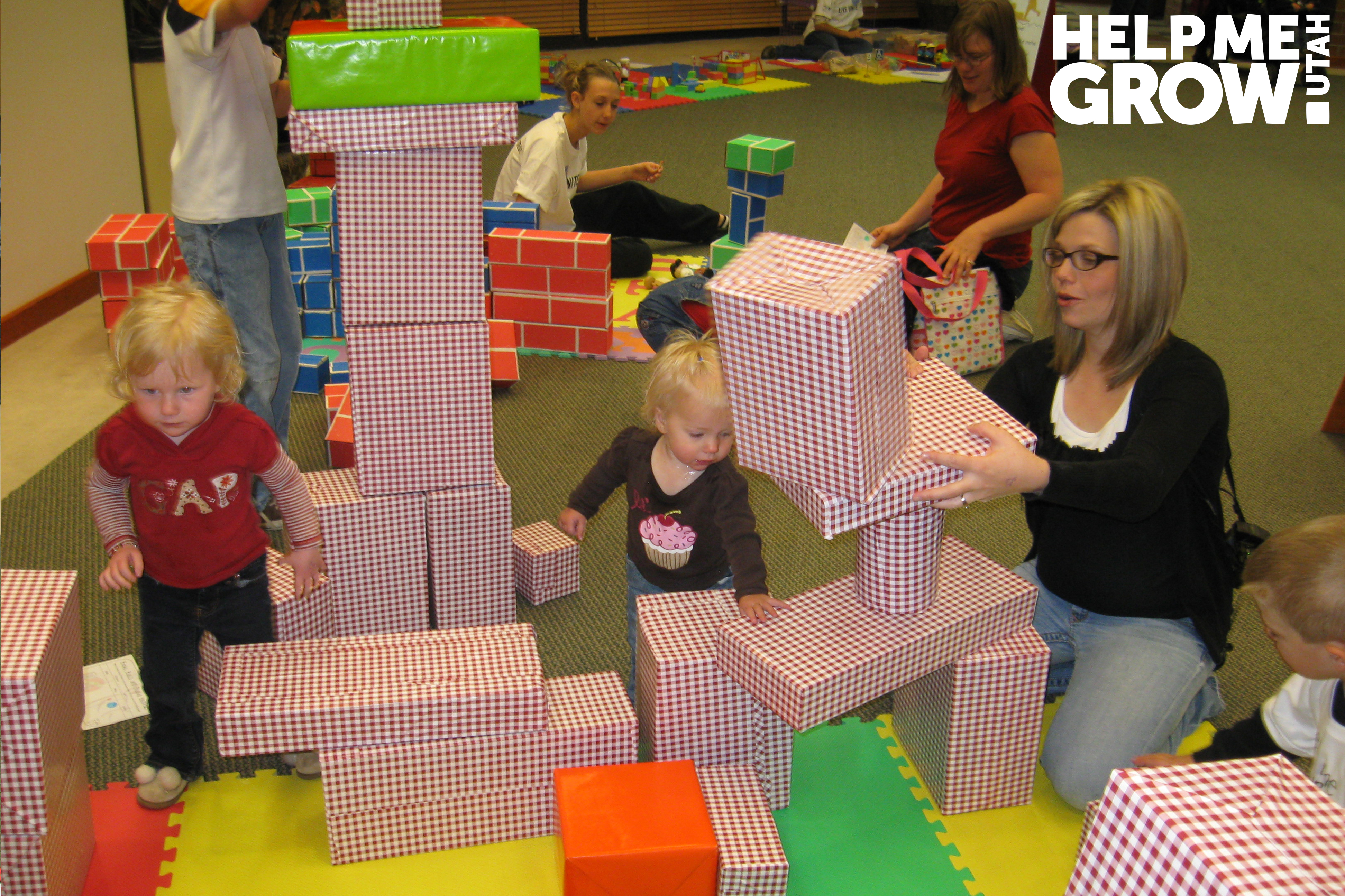 Mother and young daughter stack blocks together at a Books Blocks & Balls event in Utah