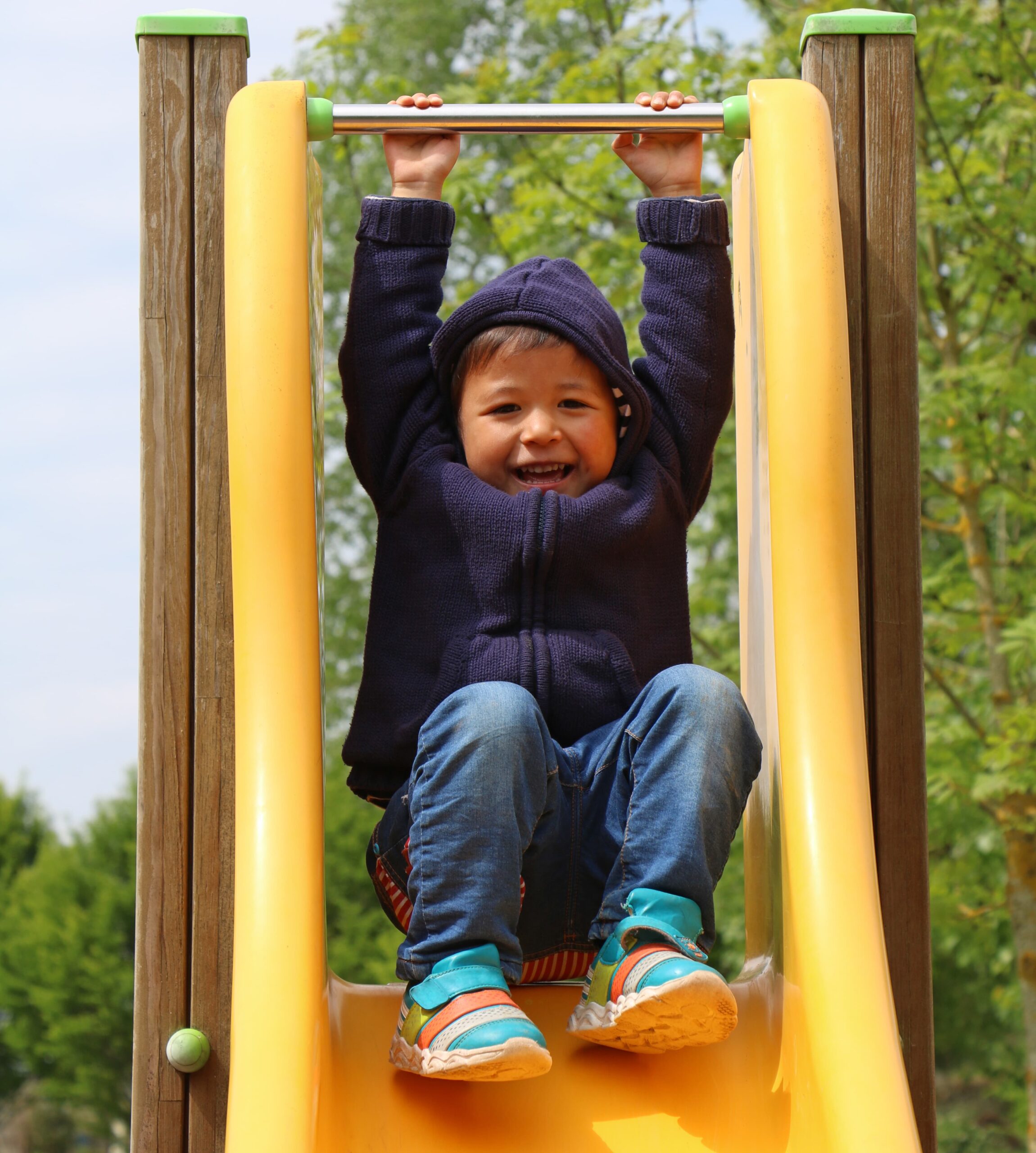 Toddler playing on slide